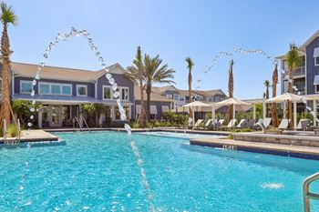 Swimming pool with decorative water features and lounge seating